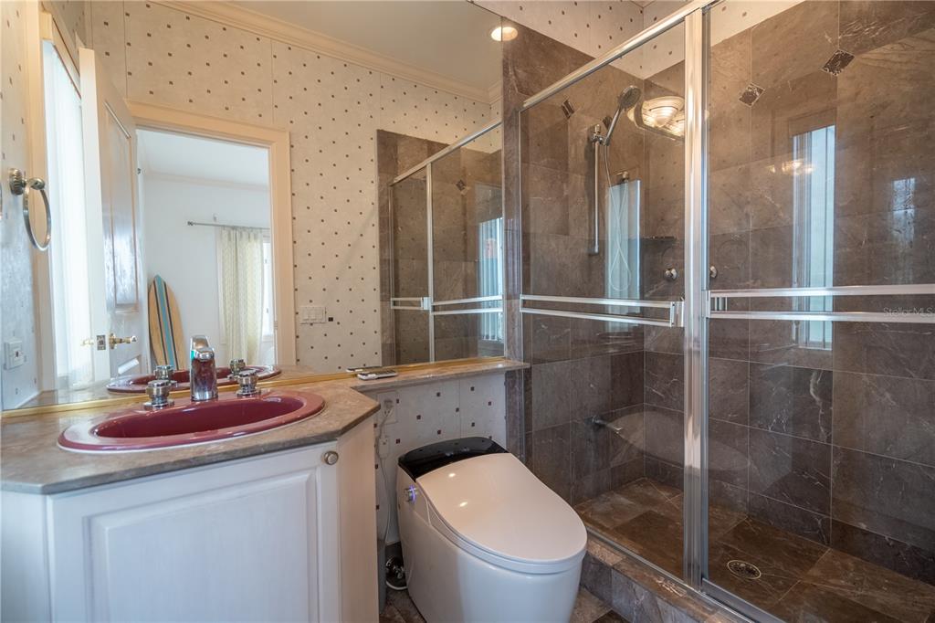 6060 Manasota Key Road Englewood, FL 34223 - Photo 35 of 54 a bathroom with a sink toilet and shower