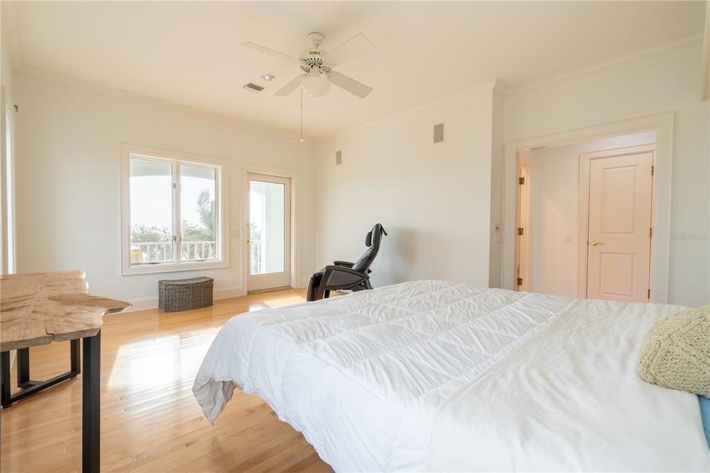 6060 Manasota Key Road Englewood, FL 34223 - Photo 38 of 54 a bedroom with a bed and wooden floor