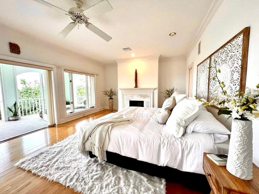 6060 Manasota Key Road Englewood, FL 34223 - Photo 7 of 54 a bedroom with a large bed and a chandelier