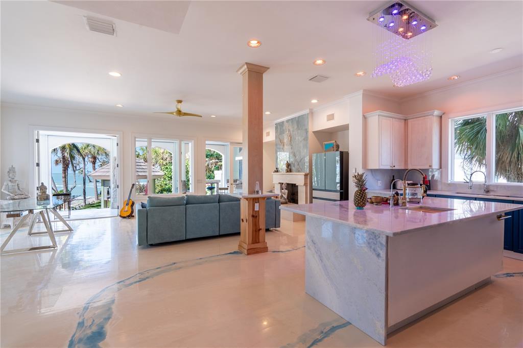 6060 Manasota Key Road Englewood, FL 34223 - Photo 9 of 54 a large kitchen with kitchen island a large counter top stainless steel appliances and cabinets