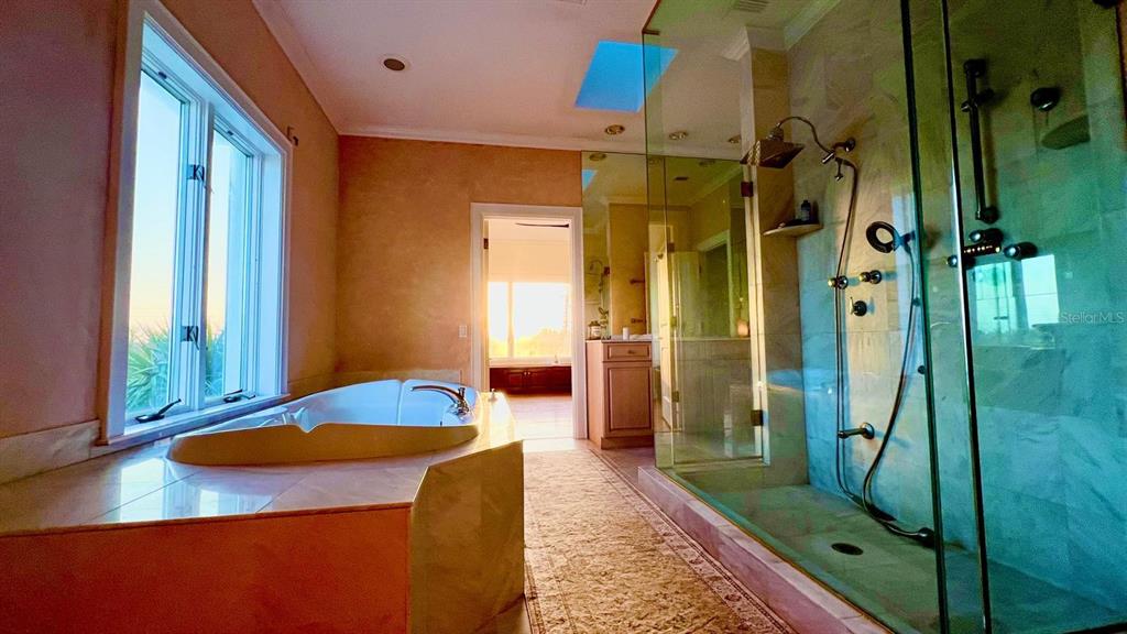 6060 Manasota Key Road Englewood, FL 34223 - Photo 10 of 54 a bathroom with a granite countertop sink and shower