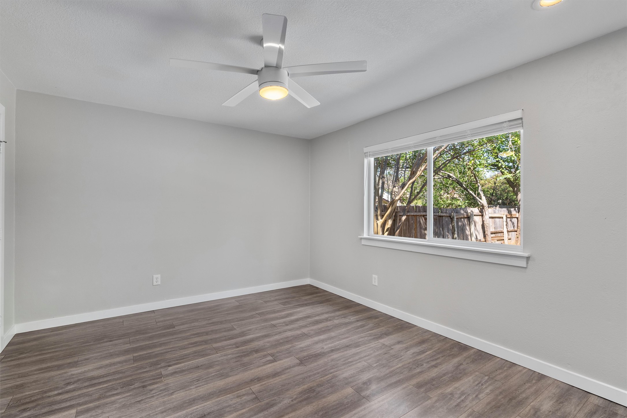 12321 Emery Oaks Road Austin, TX 78758 - Photo 15 of 27 A spacious and private bedroom overlooking the private backyard offers ample natural light from a wide window.
