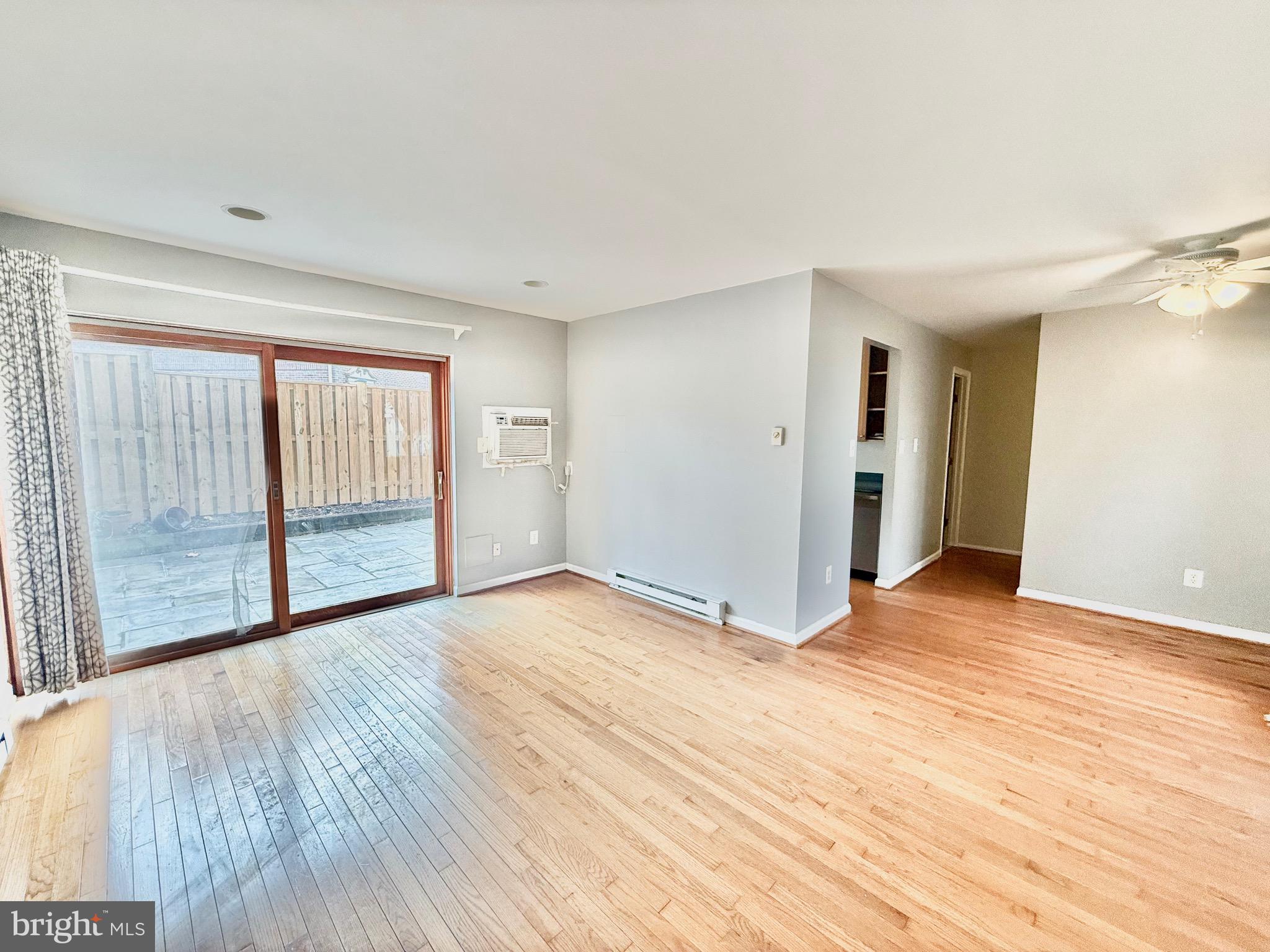 720 West Glebe Road, Unit 2A Alexandria, VA 22305 - Photo 2 of 15 a view of an empty room with wooden floor and a window