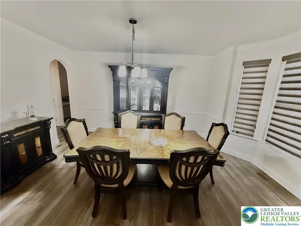 a view of a livingroom with furniture window and wooden floor