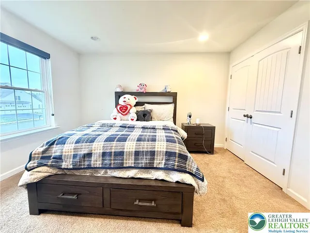 a bedroom with a bed and window