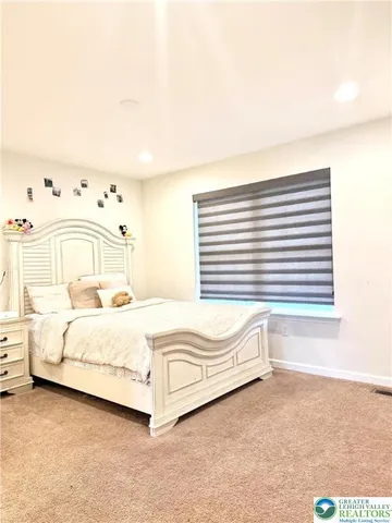 a bed sitting in a bedroom next to a window