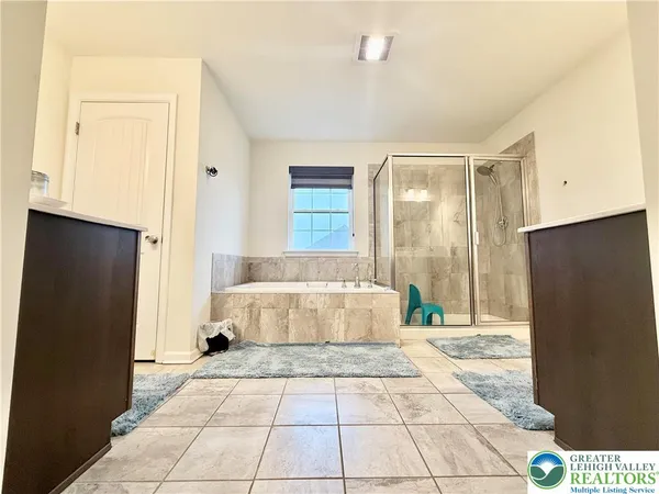 a bathroom with a bathtub and shower