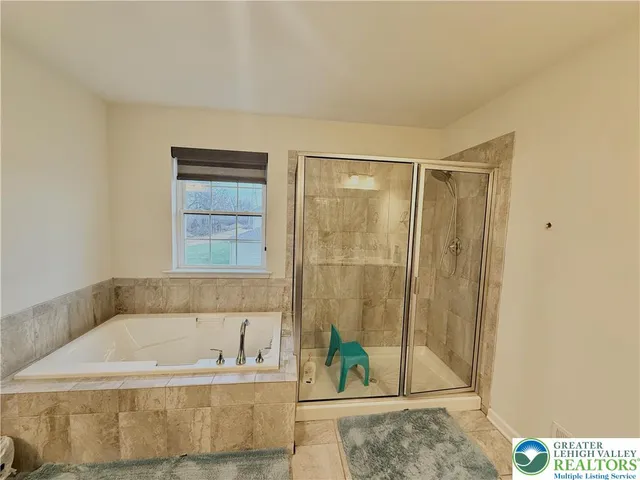 a bedroom with a large bed and a view of living room