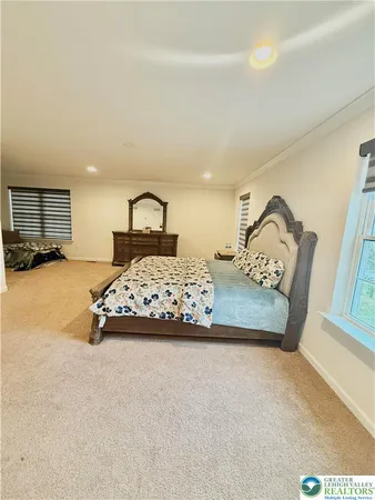 a bedroom with a large bed and a window