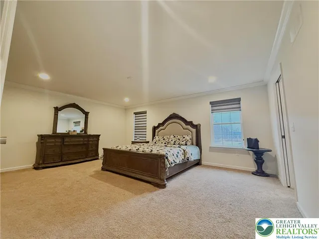 a bedroom with a large bed and a window