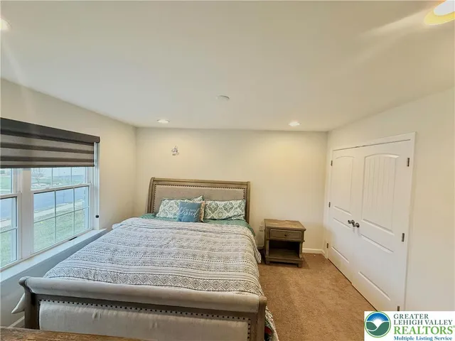 a bedroom with a bed and a desk