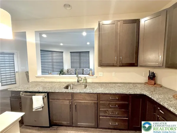 a kitchen with granite countertop a sink and a window