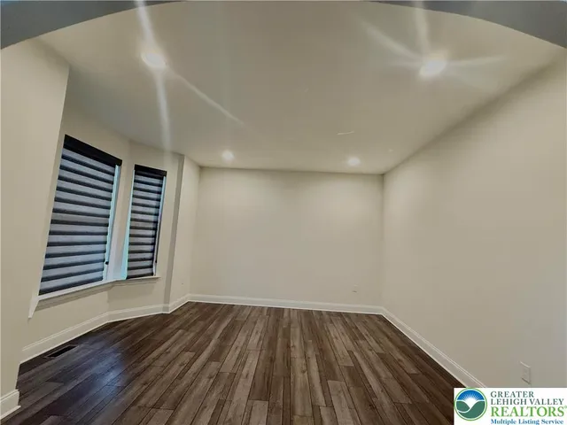 a view of an empty room and wooden floor