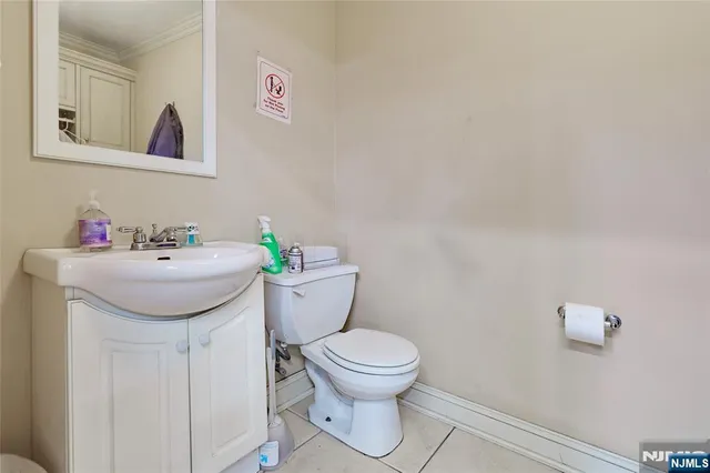 a bathroom with a sink toilet and a mirror