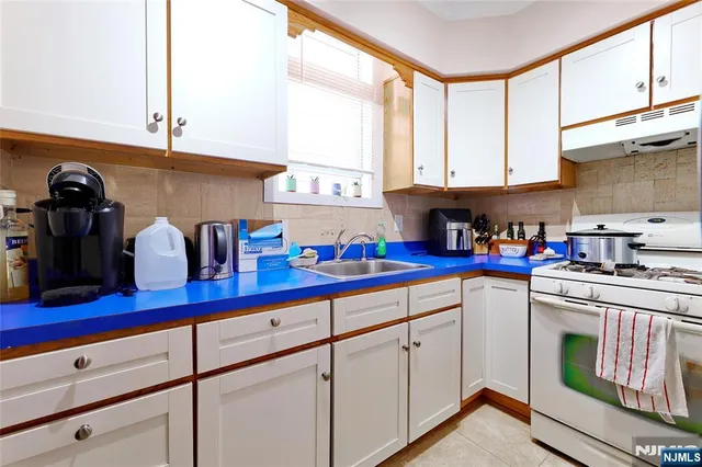 a kitchen with appliances cabinets and a sink