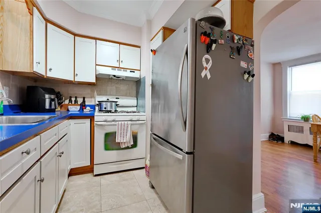 a kitchen with stainless steel appliances a refrigerator sink and cabinets