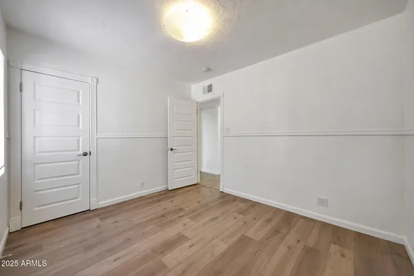 an empty room with wooden floor