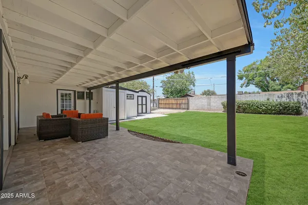 a view of a house with backyard and porch