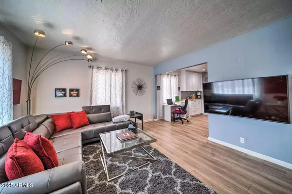 a dinning room with furniture a rug and a flat screen tv