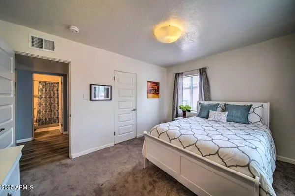 a bedroom with furniture and a window