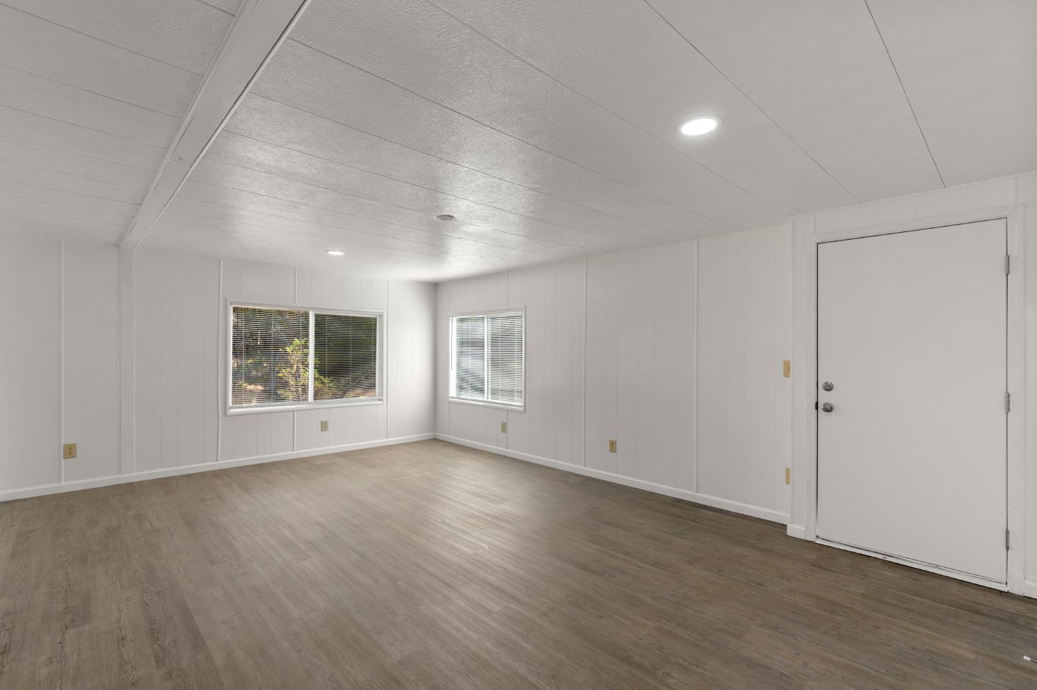 10155 Peppermint Circle, Unit 35 Jamestown, CA 95327 - Photo 15 of 27 a view of an empty room with wooden floor and a window