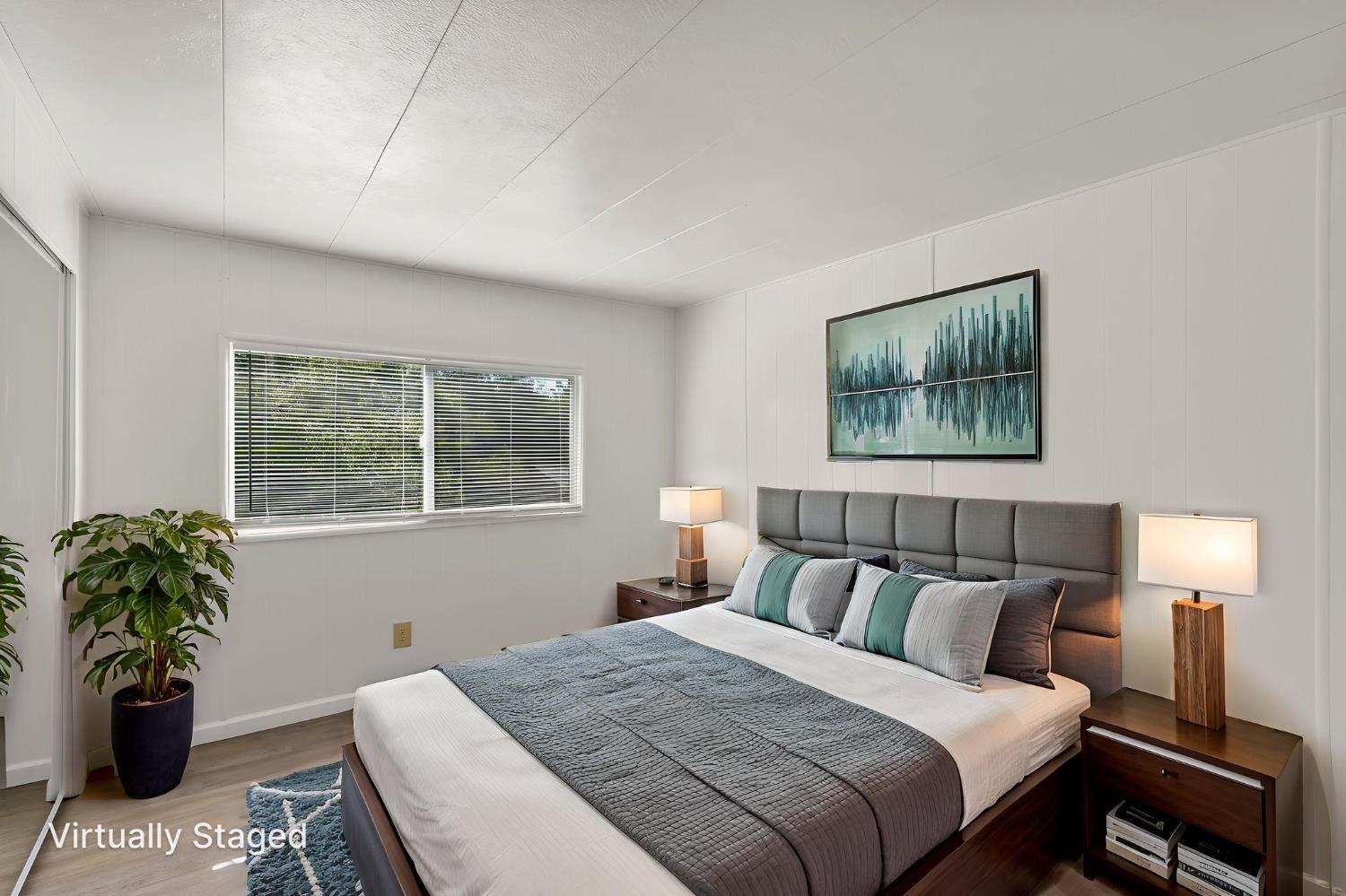 10155 Peppermint Circle, Unit 35 Jamestown, CA 95327 - Photo 17 of 27 a bedroom with a bed and a painting on the wall