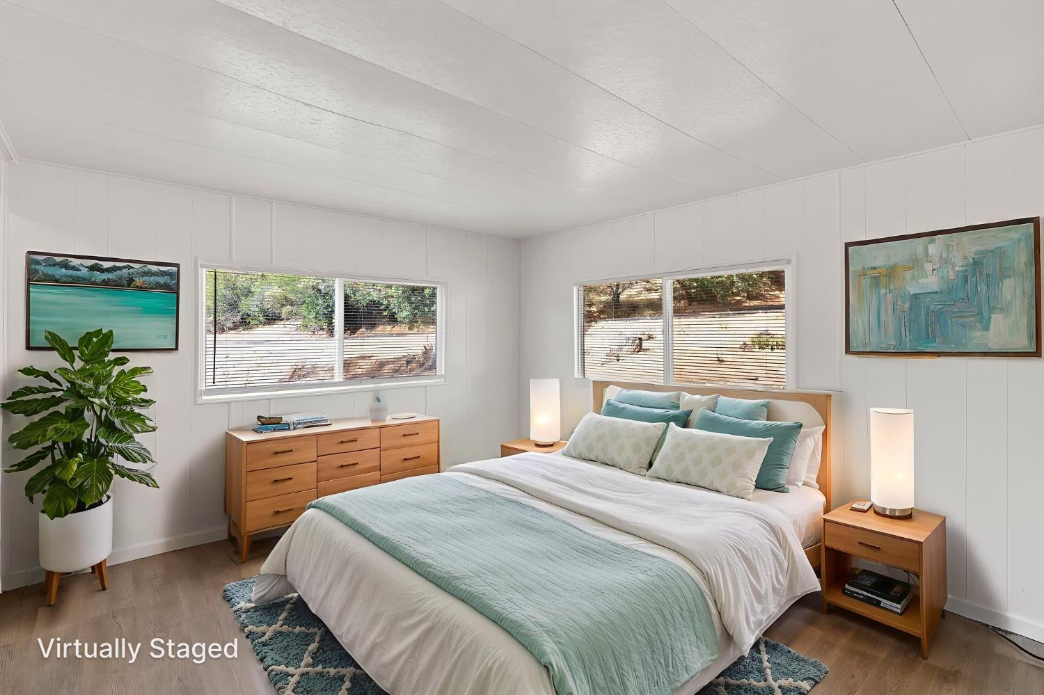10155 Peppermint Circle, Unit 35 Jamestown, CA 95327 - Photo 21 of 27 a bedroom with a large bed and a potted plant