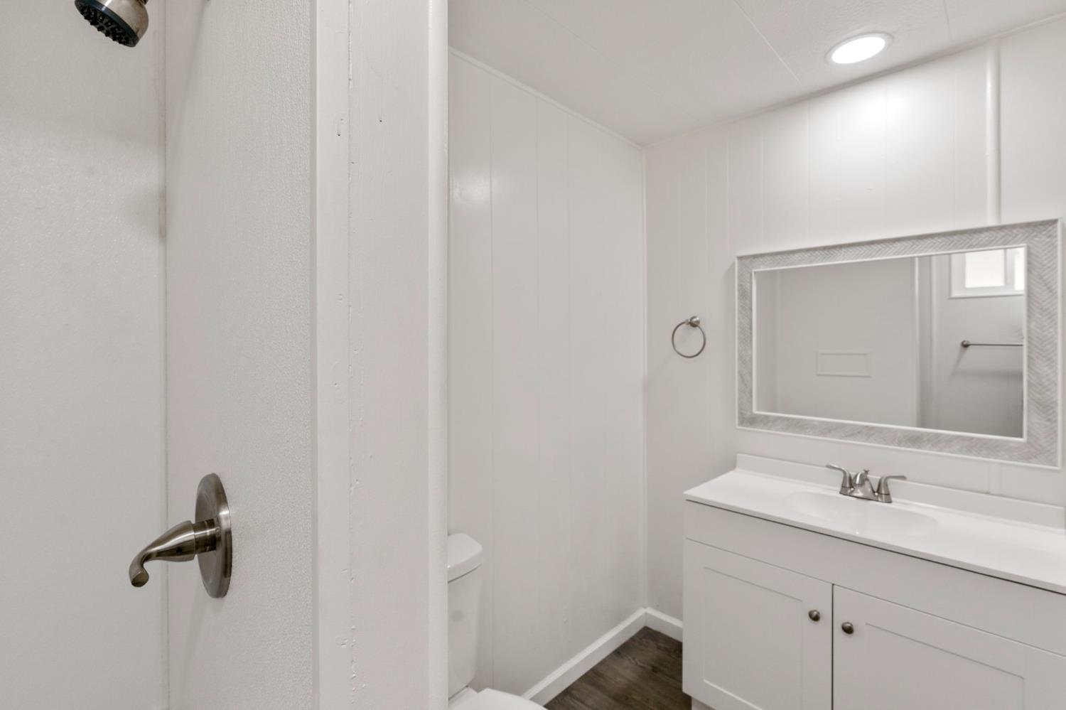 10155 Peppermint Circle, Unit 35 Jamestown, CA 95327 - Photo 22 of 27 a bathroom with a sink and mirror