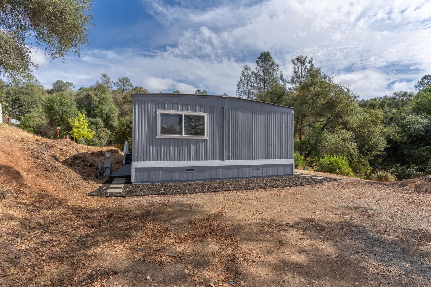 10155 Peppermint Circle, Unit 35 Jamestown, CA 95327 - Photo 5 of 27 a view of a house with a yard and garage