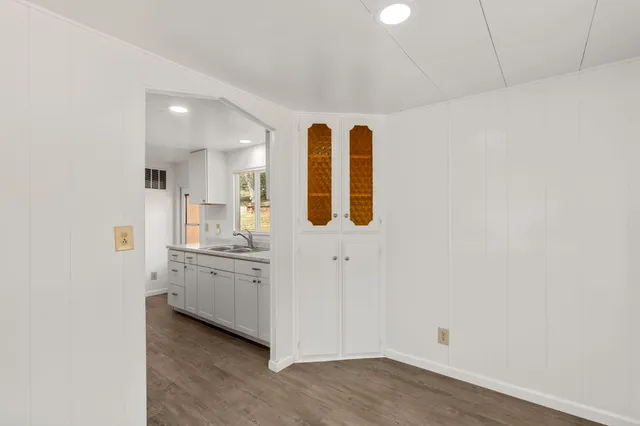 a view of a kitchen with white cabinets