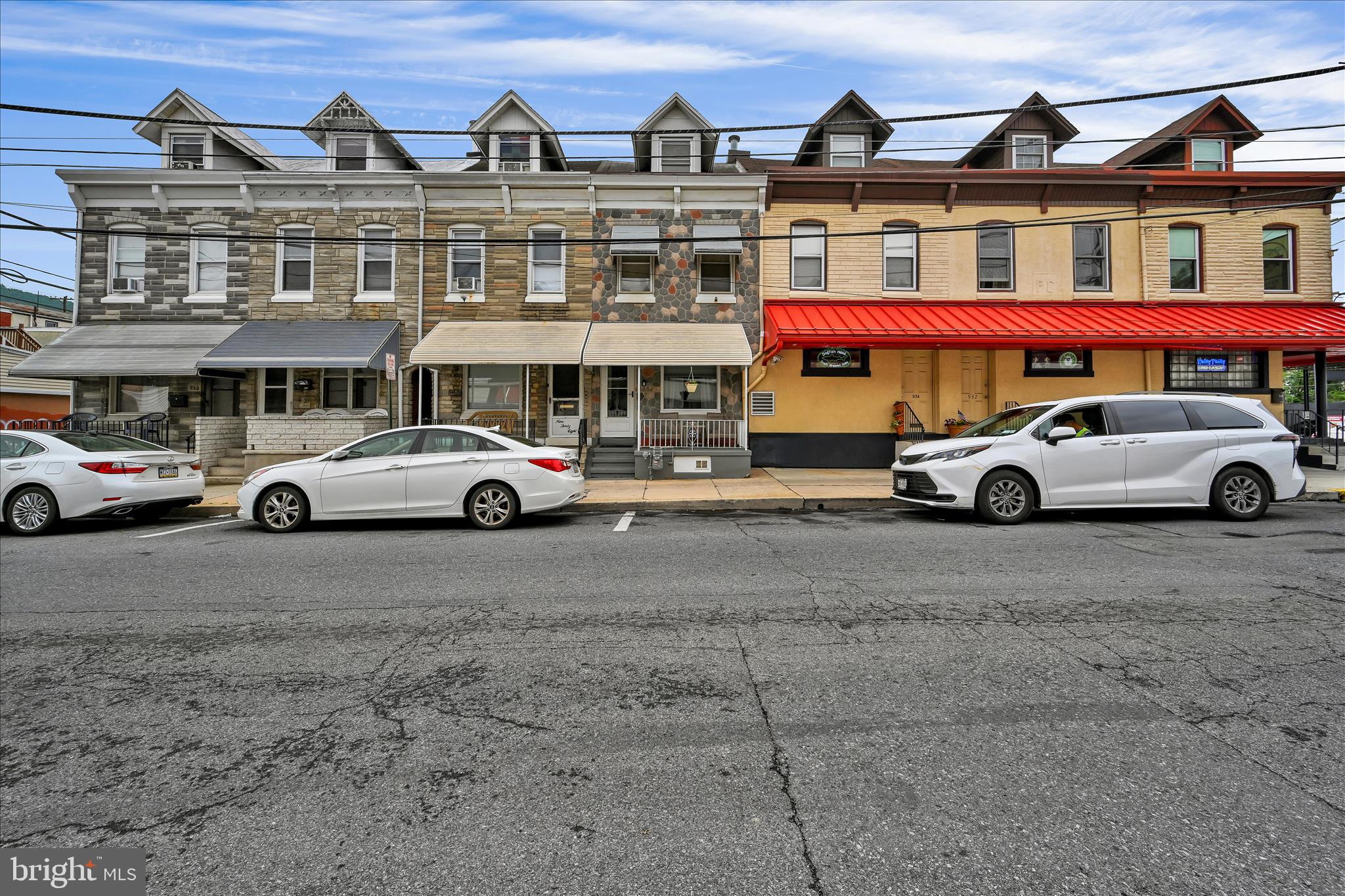 936 Pike Street Reading, PA 19604 - Photo 1 of 24 a front view of a building with parking space and a car parked in front of it