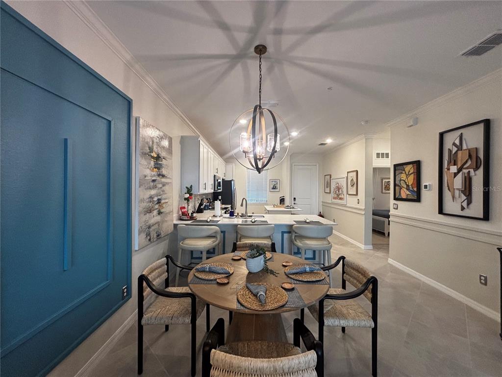 12140 Wellen Golf Street, Unit 404 Venice, FL 34293 - Photo 11 of 55 a view of a dining room with furniture window and wooden floor