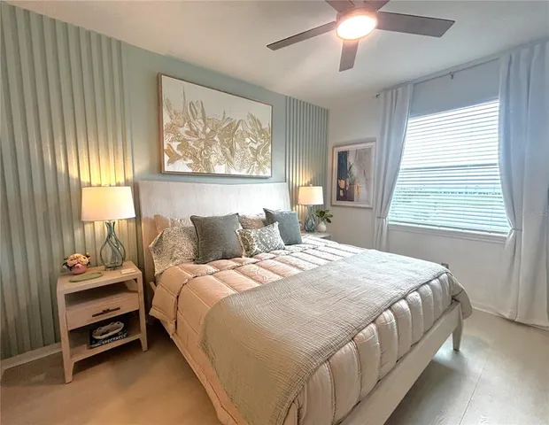a bedroom with a bed and a flat screen tv on the dresser