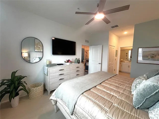 a bedroom with a bed and flat screen tv