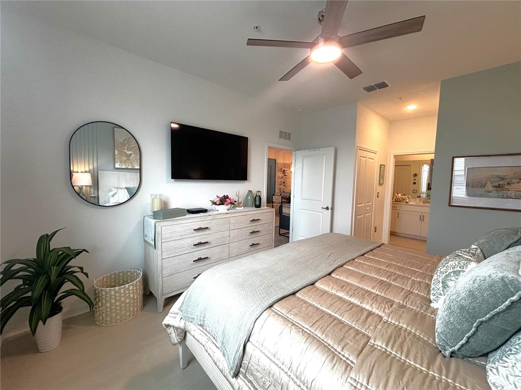 12140 Wellen Golf Street, Unit 404 Venice, FL 34293 - Photo 17 of 55 a bedroom with a bed window and a flat screen tv