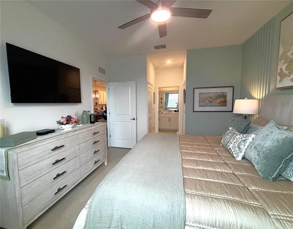 a bedroom with a bed and a chandelier