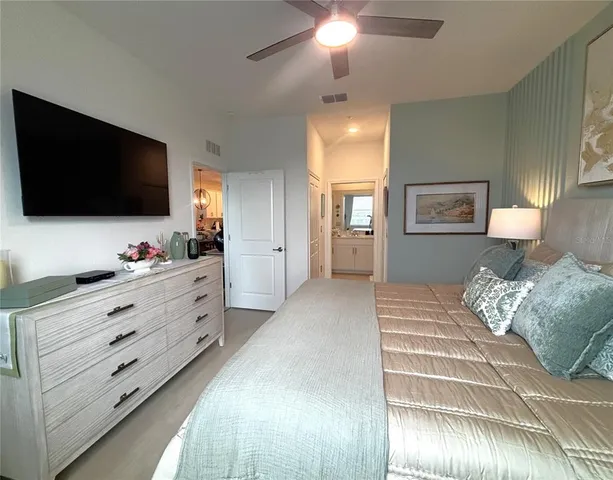 a bedroom with a bed and a chandelier