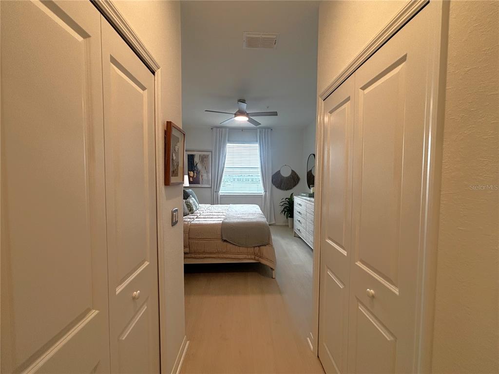 12140 Wellen Golf Street, Unit 404 Venice, FL 34293 - Photo 19 of 55 a bedroom with a bed and a chandelier