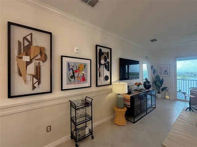 a living room with furniture a flat screen tv and wooden floor