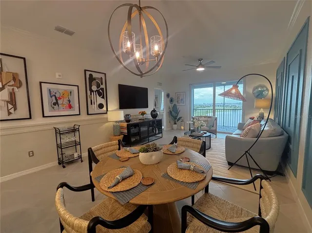 a view of a dining room with furniture wooden floor and chandelier