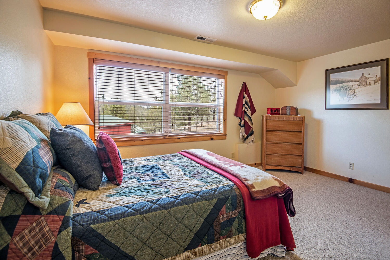 70700 Holmes Road Sisters, OR 97759 - Photo 27 of 53 Downstairs, 384 SF includes a carpeted guest bedroom with its own private access and a laundry room with a washer & dryer