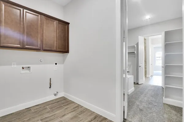 a view of a kitchen with wooden floor and cabinets