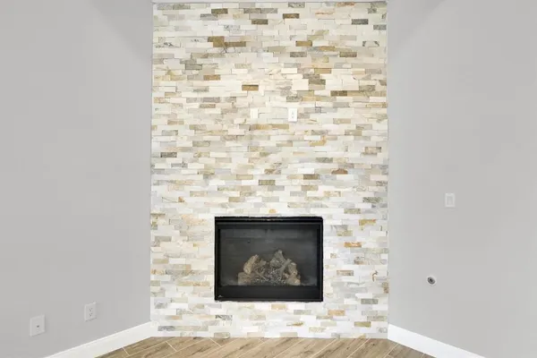 a stone house with a fireplace