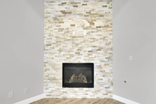 a stone house with a fireplace