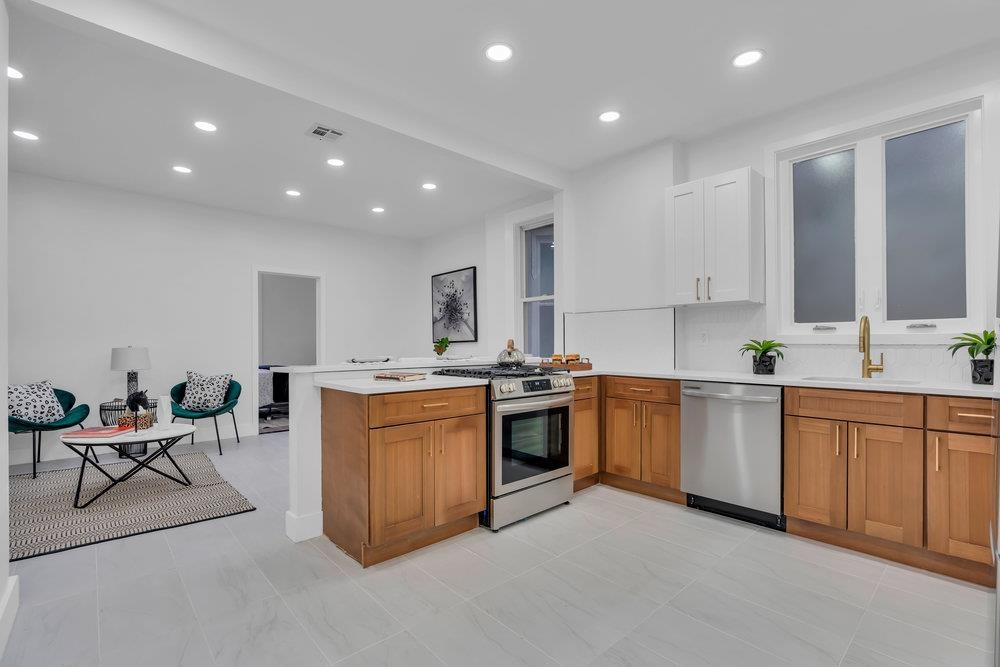 a large kitchen with stainless steel appliances granite countertop a large center island and a sink