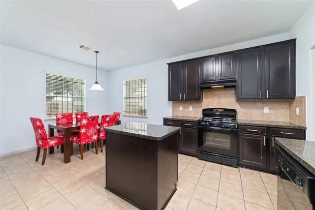 a kitchen with a stove a sink dishwasher and a refrigerator