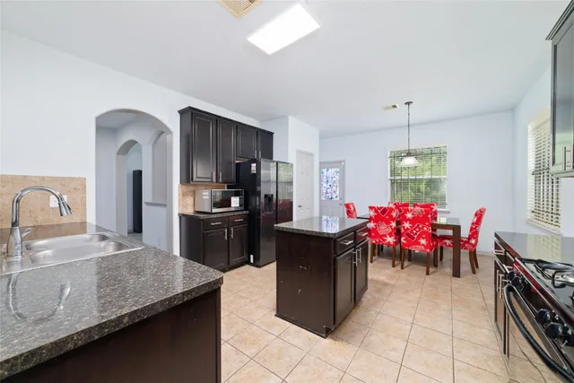 a kitchen with a sink and cabinets