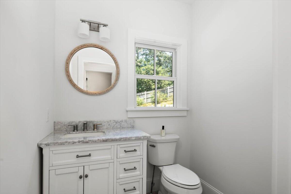 4 Nickerson's Circle South Chatham, MA 02659 - Photo 15 of 37 a bathroom with a granite countertop toilet a sink and a window