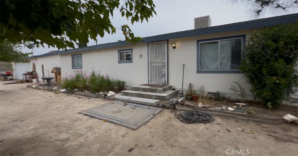 9372 Mesa Road Lucerne Valley, CA 92356 - Photo 2 of 3 a backyard of a house with yard and outdoor seating