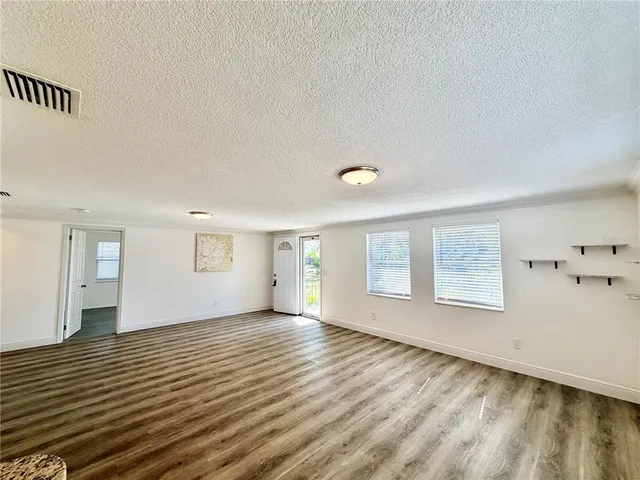 a kitchen with a sink dishwasher a stove top oven a refrigerator with island and cabinets